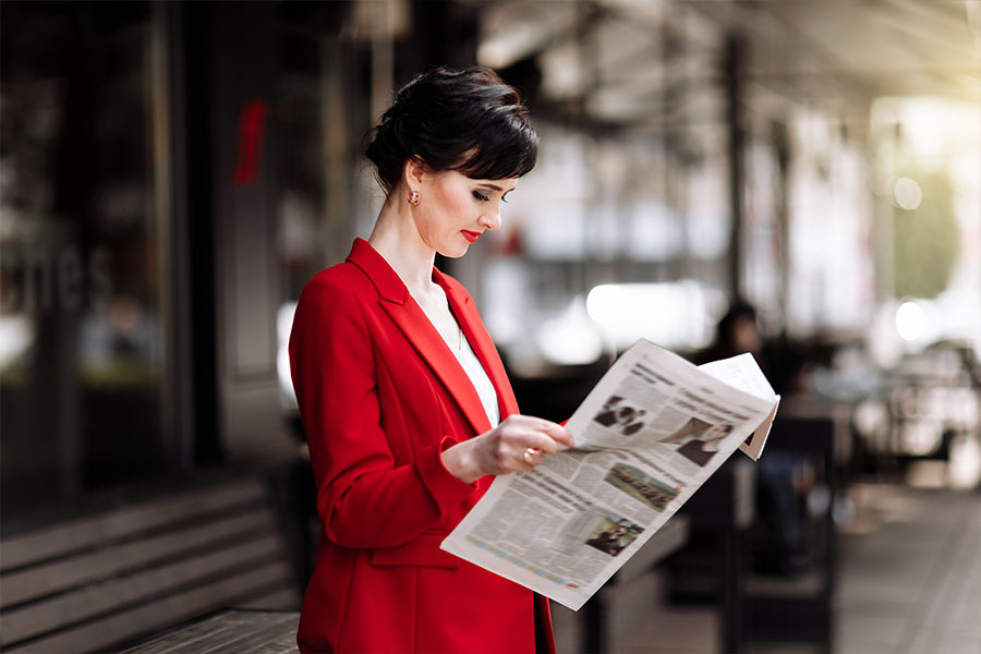This lady is happy to read a newspaper. Print materials are still important.