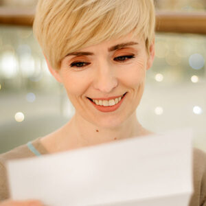 Happy lady reading a letter